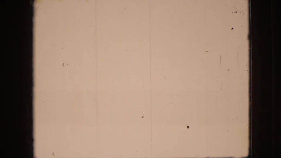 1968 Branson, Missouri 8mm frame with a warm, nearly blank exposure area, dark film-frame edges, and visible dust and scratch marks.