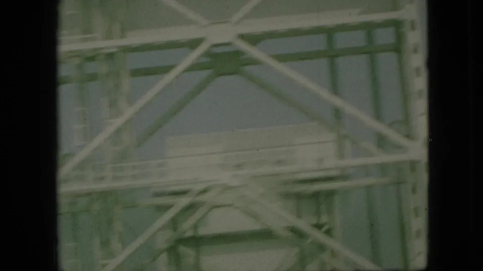 Close 8mm view of steel bridge cross-bracing and side railing in Branson, Missouri, filmed from a moving vehicle in 1968.
