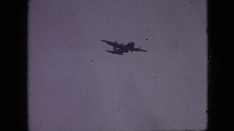 A small propeller airplane continues across the pale sky in the final 1968 Branson, Missouri 8mm frame, with subdued exposure and visible scan borders.