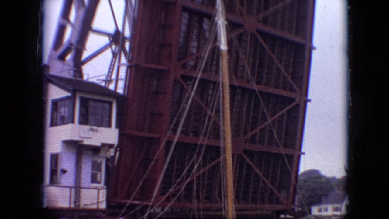 A 1968 Branson, Missouri home-movie frame shows the raised metal drawbridge structure and a small white control booth at the water's edge.