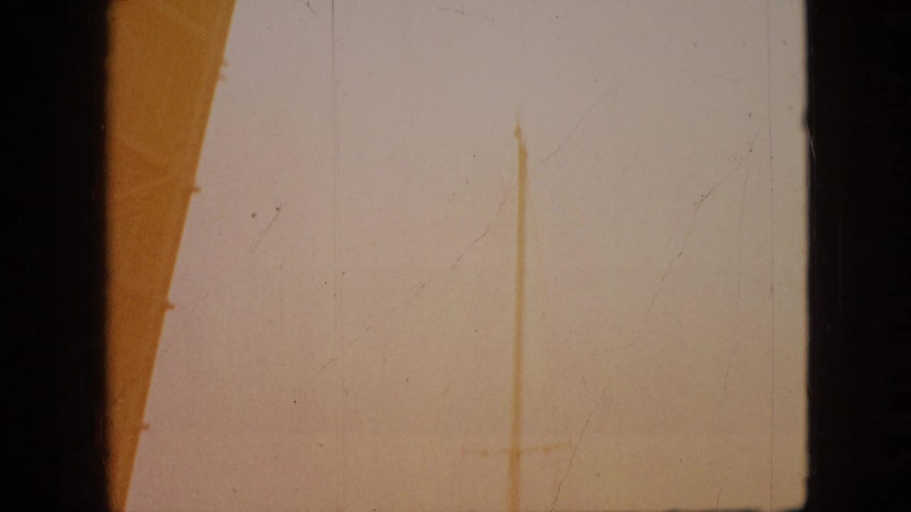1968 8mm home-movie frame from the Branson clip showing a mostly overexposed view bordered by dark window or structural edges.