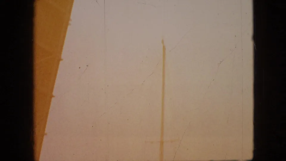1968 8mm home-movie frame from the Branson clip showing a mostly overexposed view bordered by dark window or structural edges.
