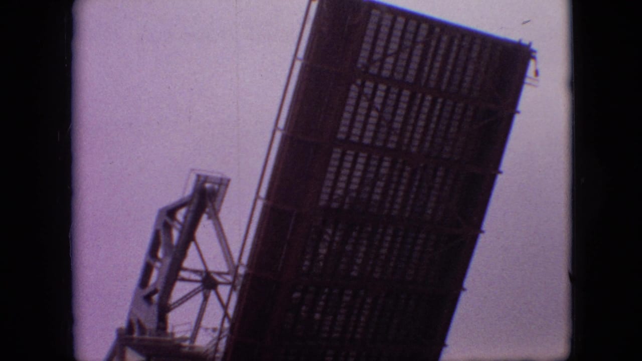 1968 Branson, Missouri 8mm frame showing a raised bascule bridge leaf with gridded metal decking beside a mechanical support tower.