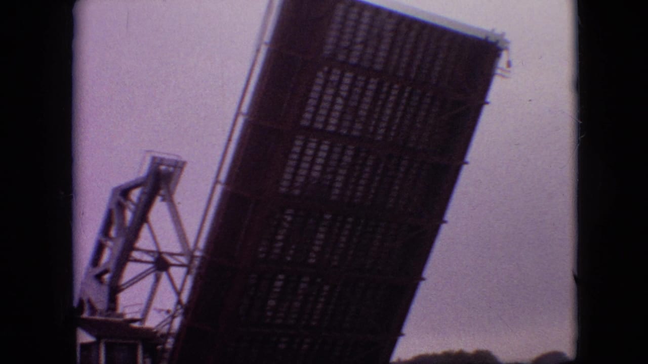 Close view of the raised bridge leaf and adjacent steel tower.