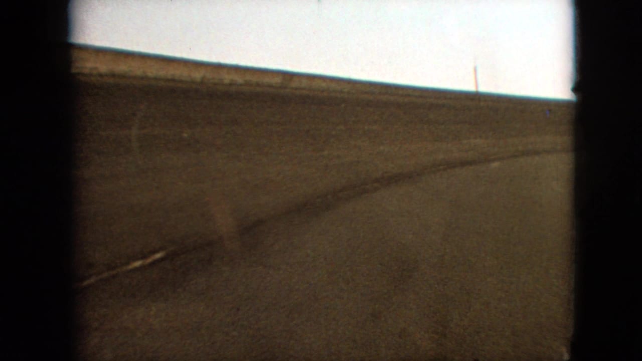 Asphalt track curve with dark frame borders and a faint track edge line.