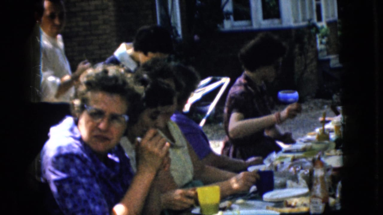 A woman in a blue patterned top looks toward the camera beside other diners.
