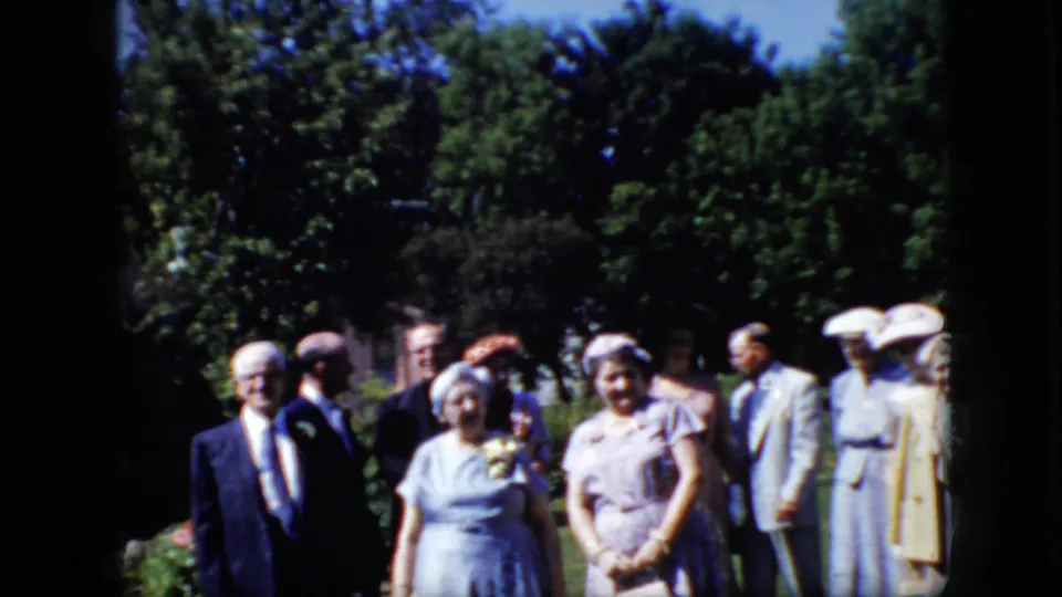 The final frame shows older adults in formal 1960s attire standing in a sunny park-like California setting, with dense trees and lawn visible around them.