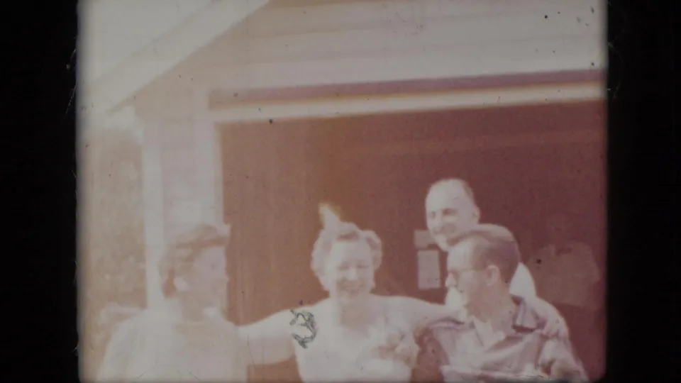 In the final 1969 California frame, the same group remains close together outside the garage, with bright overexposure softening the faces and house details.