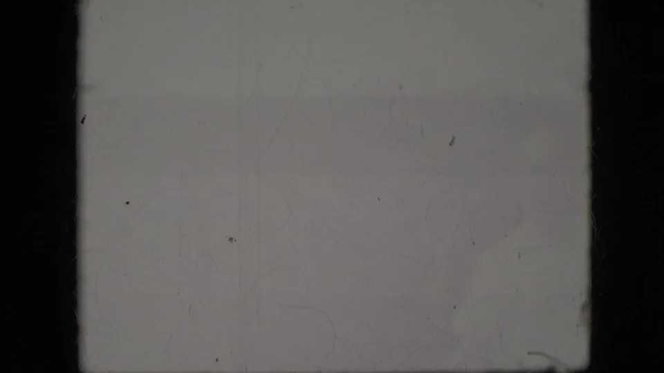 The final frame is largely overexposed or faded, showing film surface marks and only minimal trace detail from the surrounding scene.