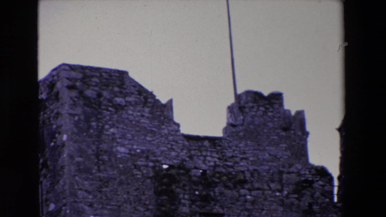 Stone ruin and crenellated wall repeated in a second 8mm frame.