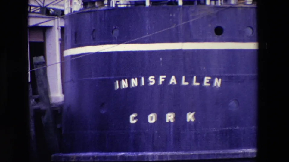 1969 Ireland 8mm frame showing the blue hull of the ship INNISFALLEN with CORK lettering, portholes, and a white stripe.