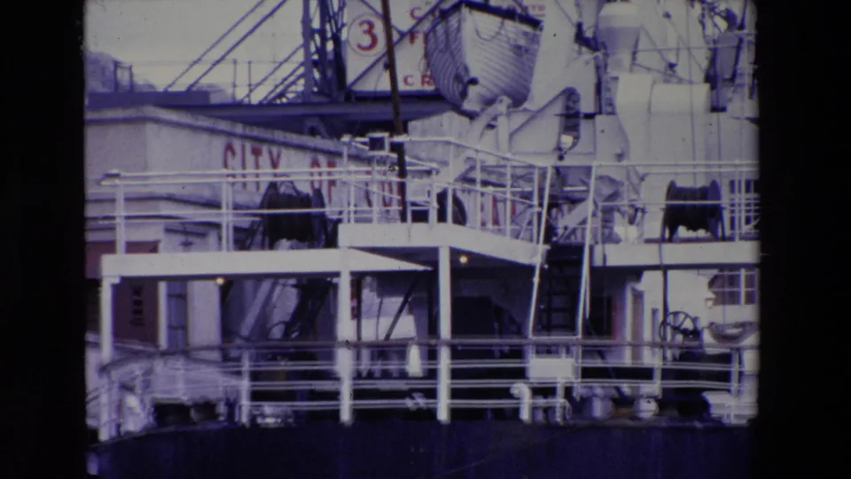 Close 1969 Irish port view of the INNISFALLEN's upper deck area, showing white railings, lifeboat equipment, ladders, and a dark hull section.