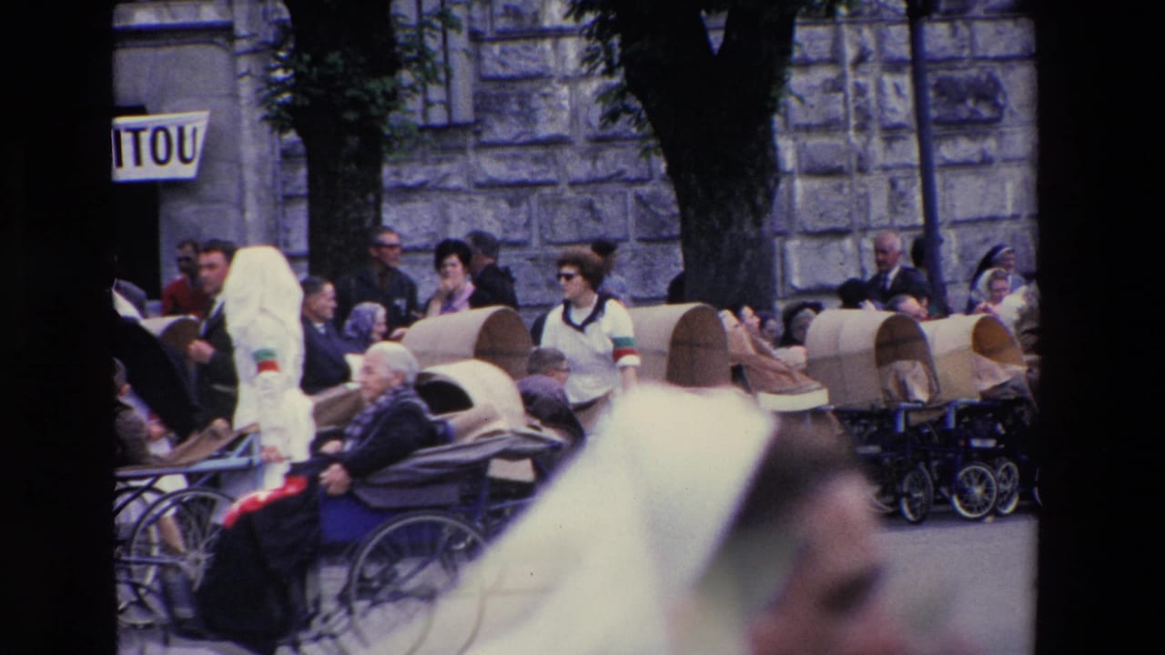 Covered carts with seated passengers pass along a street as nuns and pedestrians walk nearby.