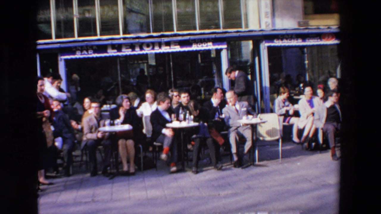 Seated cafe customers face the camera while a waiter stands near the left side.