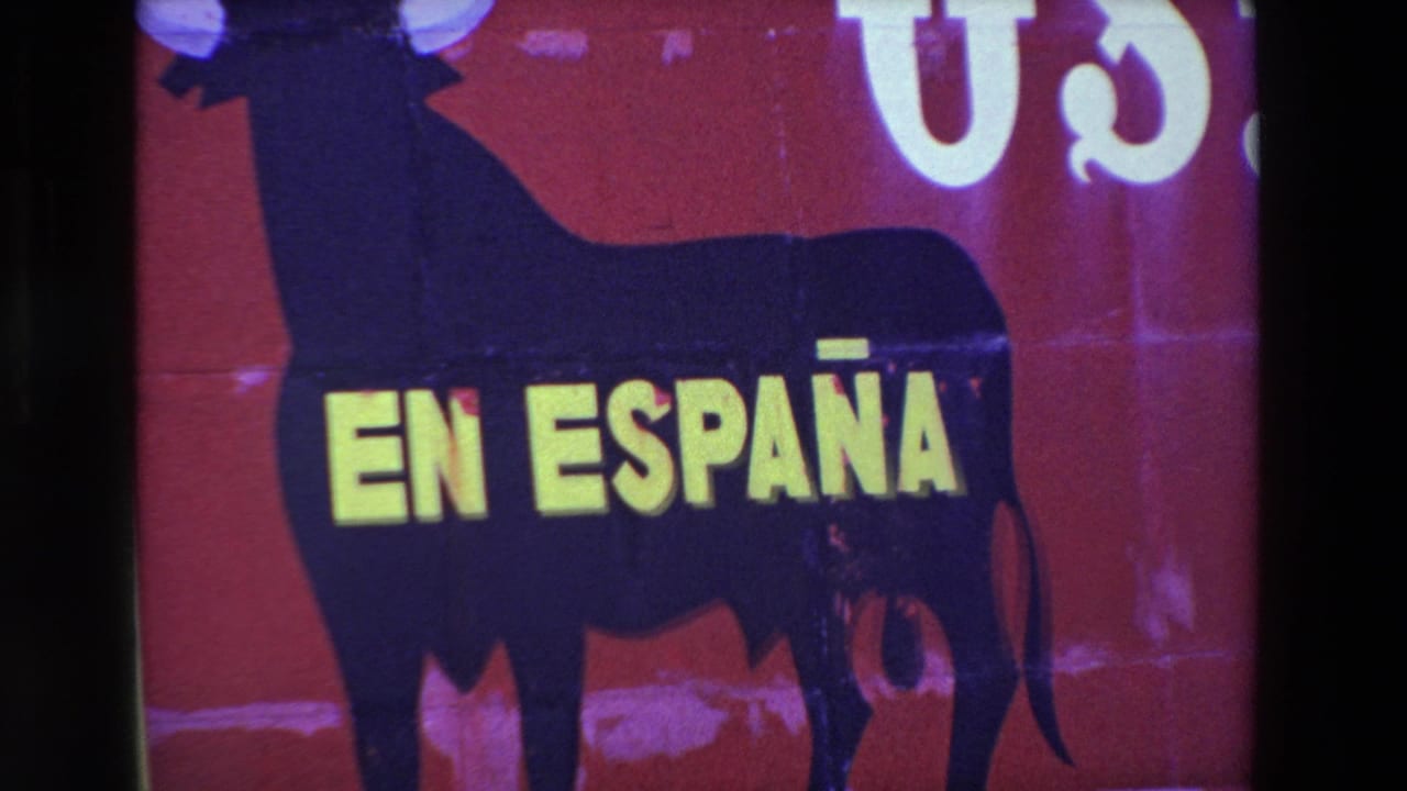 Tight crop of a black bull silhouette on a red sign with large yellow EN ESPAÑA text.