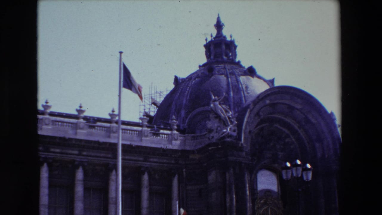 1969 Paris 8mm frame showing a French flag at half-mast beside an ornate domed historic building with visible scaffolding near the roof.