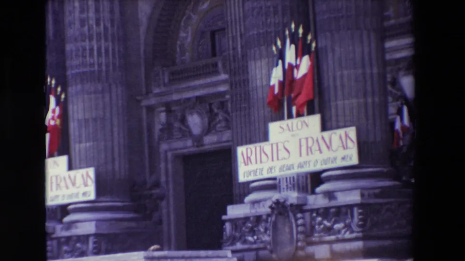 Paris, France in 1969: a closer view of the exhibition entrance shows French flags, stone columns, decorative facade details, and a Salon des Artistes Français sign above the steps.