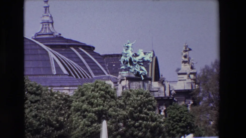 1969 Paris frame holding on a domed landmark exterior with patinated bronze horse sculpture, ornate stone elements, dense trees, and slight 8mm color fading.