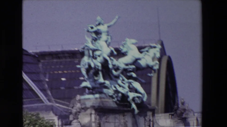 Zoomed 8mm frame from Paris in 1969 showing the sculptural horses and figures filling most of the view, with roof glazing behind them.