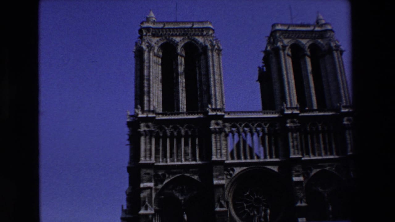 Notre-Dame Cathedral facade with twin towers under a blue sky.