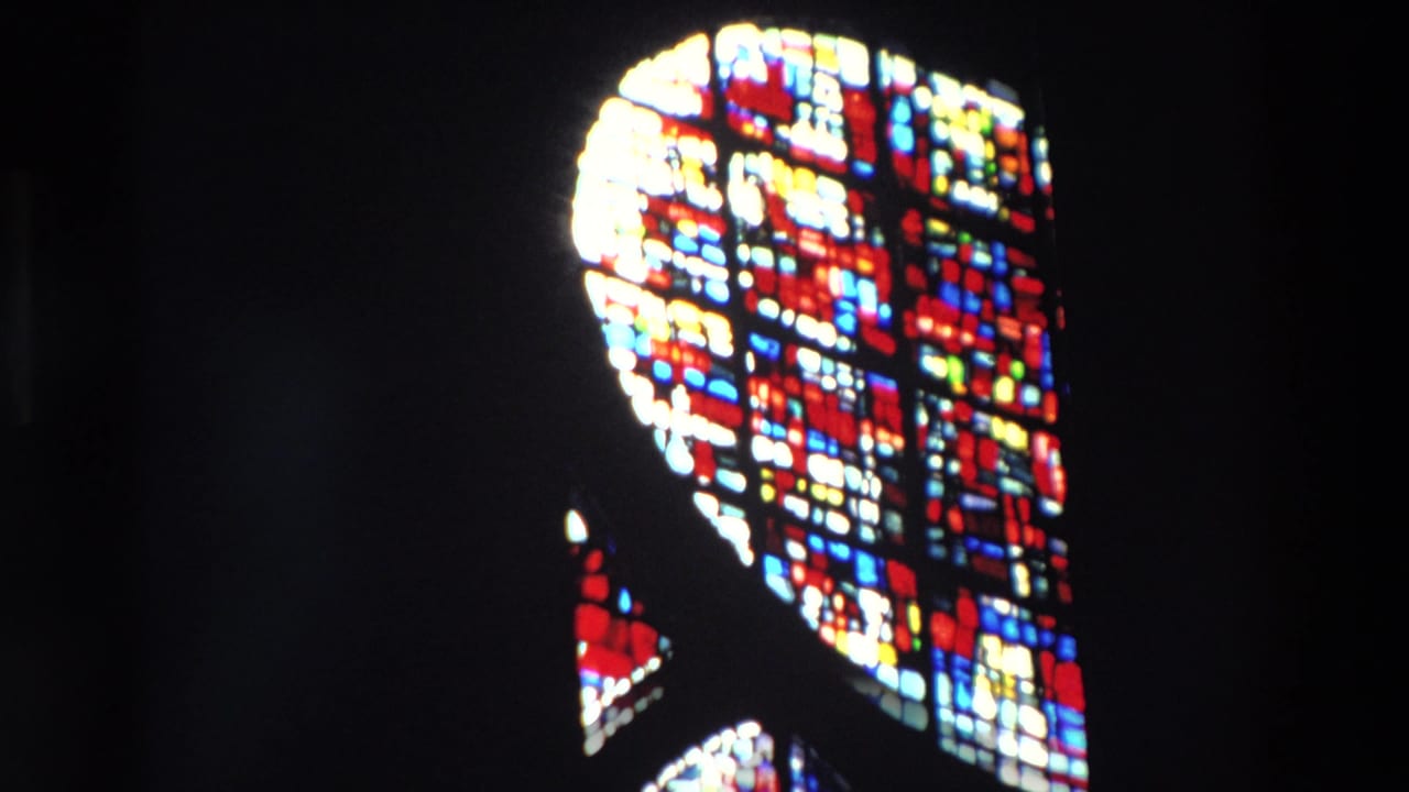 Supported 1969 Paris 8mm frame showing colorful stained glass panels glowing in a dark church interior.