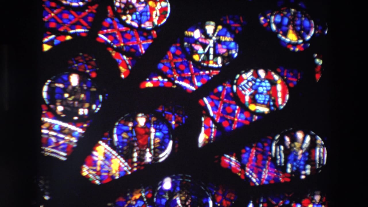 Colorful stained-glass shapes repeat across a dark field.