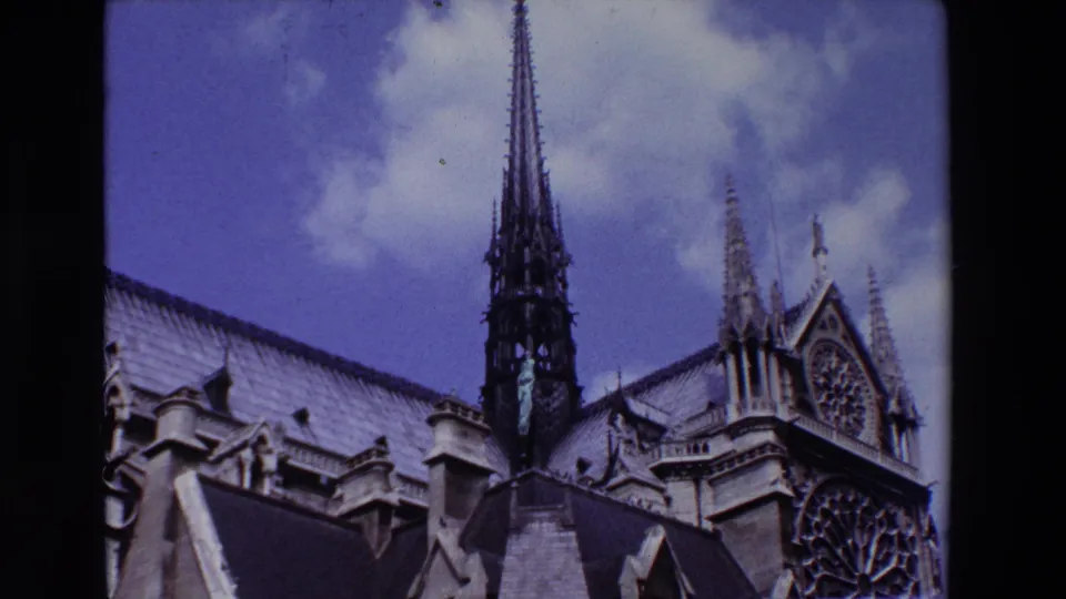 1969 Paris frame of Notre Dame Cathedral's upper structure, with the spire centered above the roofline and the rose window visible at right.