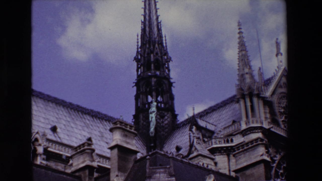 Cathedral roofline with a tall spire and ornate stone details.