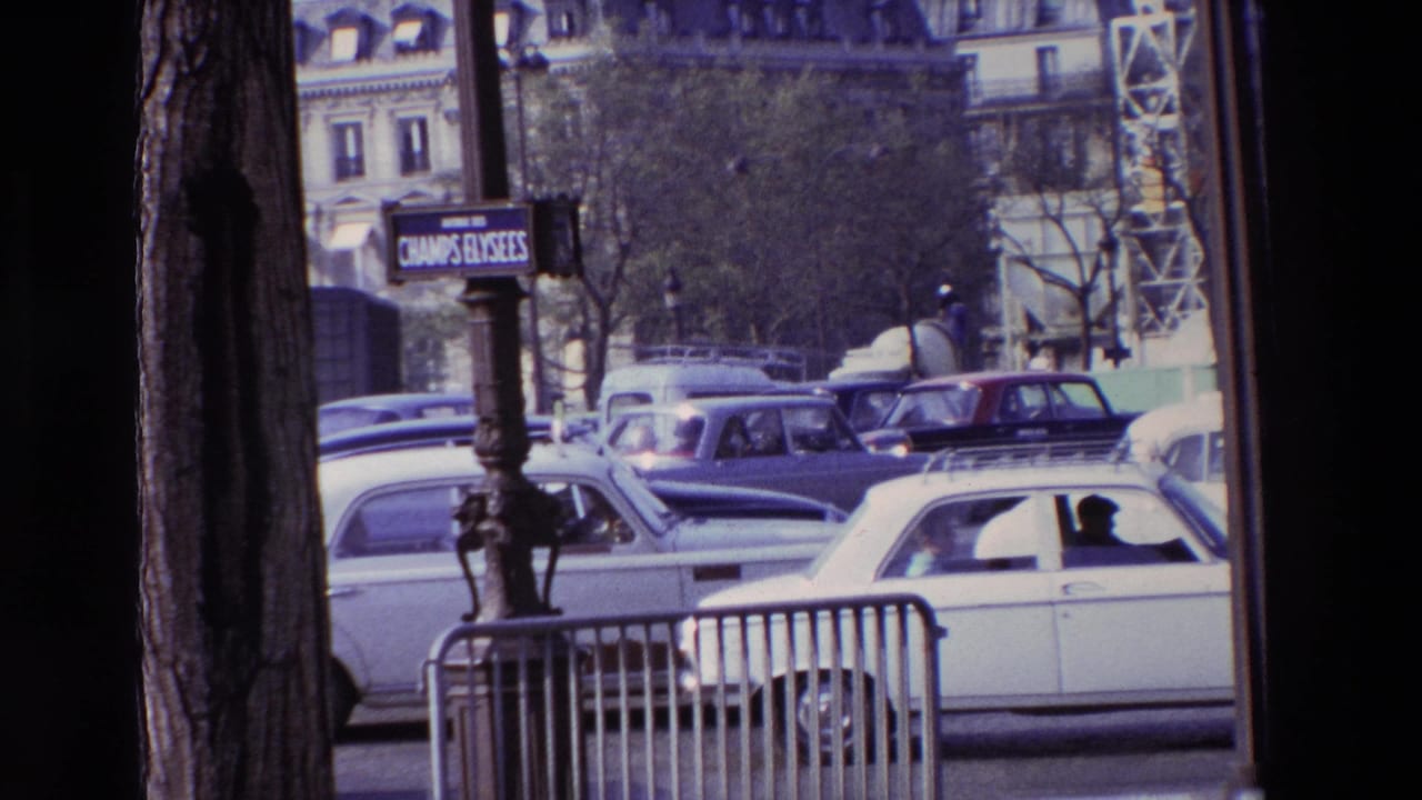 Paris street view from 1969 metadata showing a Champs-Elysees sign, older cars, metal barriers, trees, and building facades in the background.