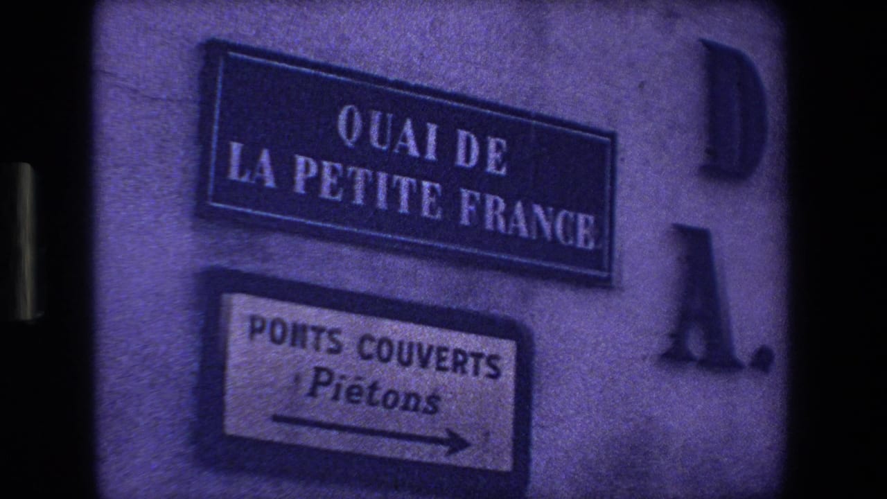 Quai de la Petite France street sign above a Ponts Couverts pedestrian arrow on a wall.