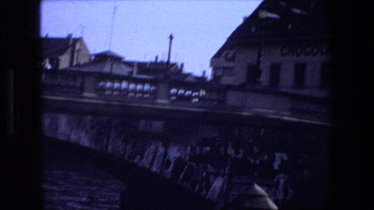 Canal bridge and riverside buildings seen from a moving handheld viewpoint.