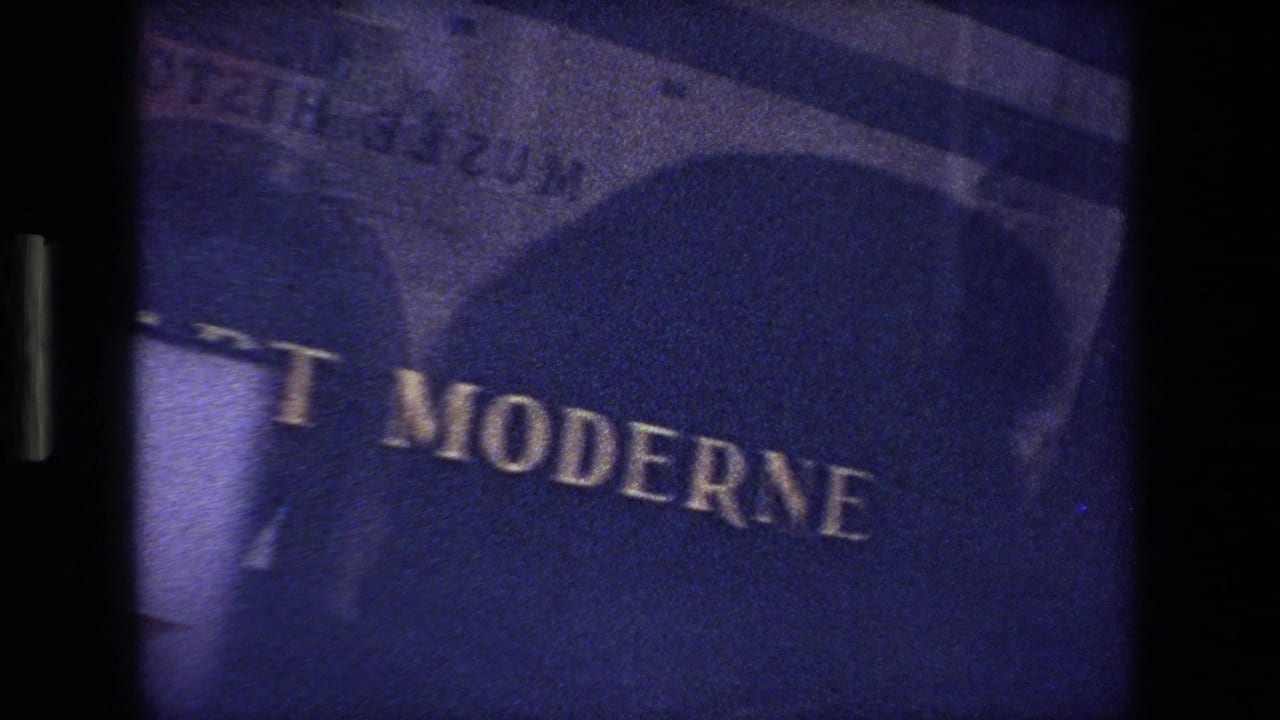 Dark blue-tinted close view of a partially readable French sign.