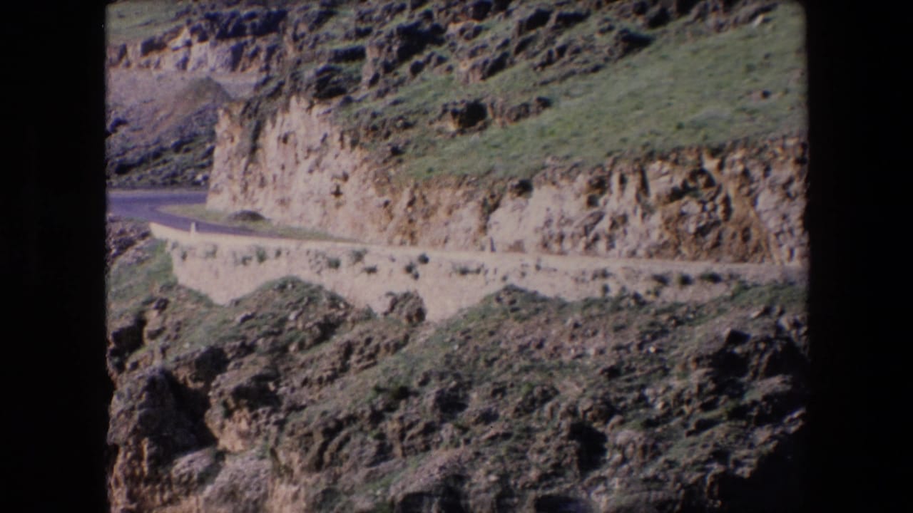 Rocky cliffside road running across a steep hillside.