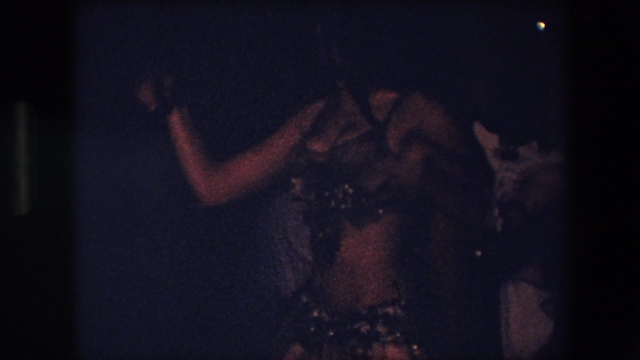 The final frame shows the dancer in side view with an extended arm, her costume and skirt partly lit while another person remains indistinct at the edge of the dark room.