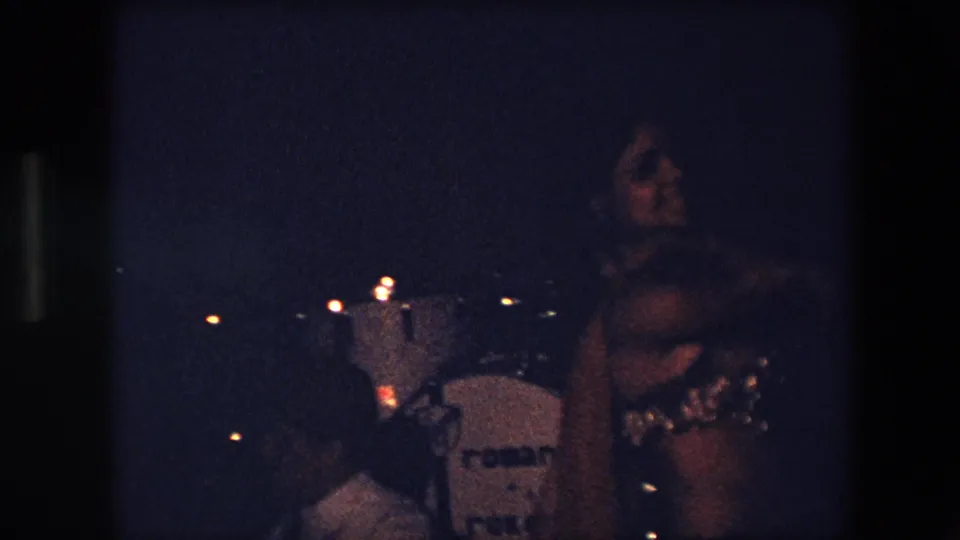 The final frame shows the sequined dancer beside a visible drum kit and seated band member in Algeria 1971 home-movie footage, with a drum brand mark faintly visible.