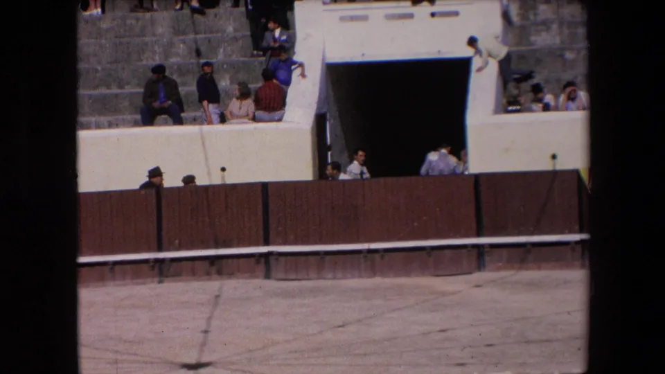 1971 Barcelona bullring view with spectators on stepped seating above a wooden barrier and a dark entrance below.