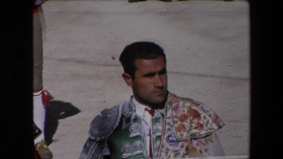 1971 Barcelona frame showing a matador's focused expression and floral embroidered shoulder detail while he stands in the bullfighting arena.