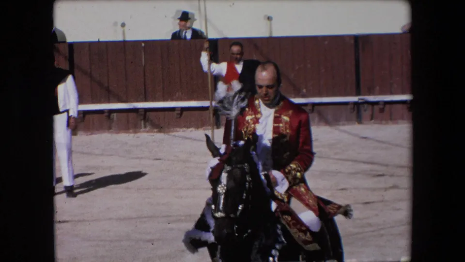 A 1971 Barcelona frame shows a rider in a red embroidered jacket mounted on a dark horse, with arena attendants and a wooden fence behind him.