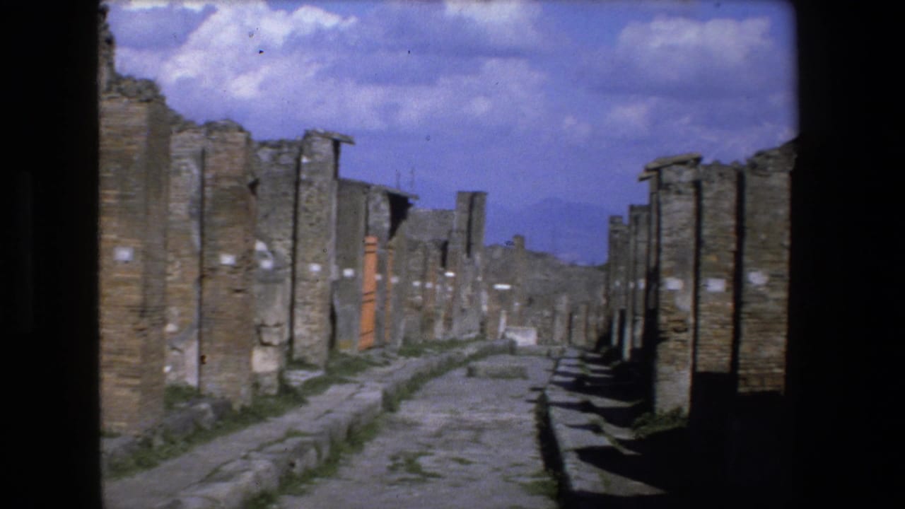 Ruined walls and a stone walkway receding into the distance.