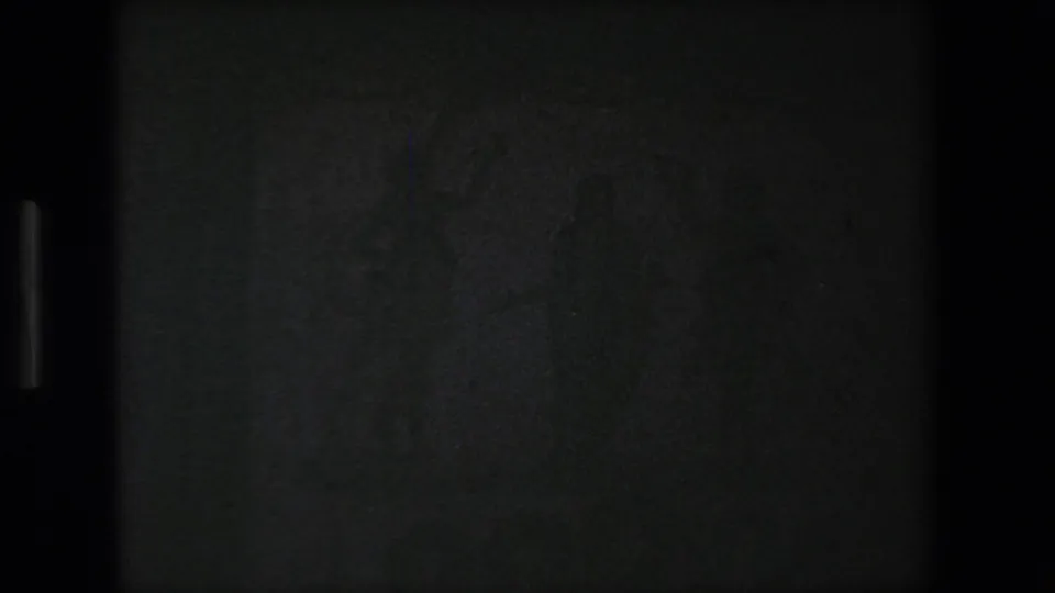 A largely underexposed or black 8mm frame appears between shots, with only faint vertical edge detail visible.