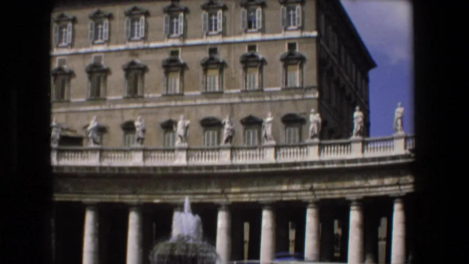 1973 Vatican City shot looking across St. Peter's Square colonnade toward the Apostolic Palace, with statues along the balustrade and fountain spray in the foreground.