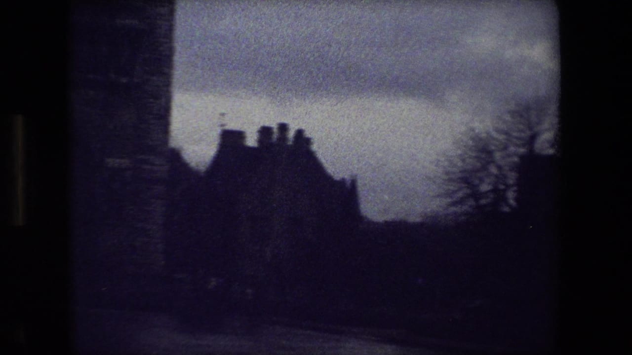 Purple-tinted 8mm view in Paris, 1981, with a dark wall, silhouetted roofline, bare tree, and overcast sky near a cemetery setting.