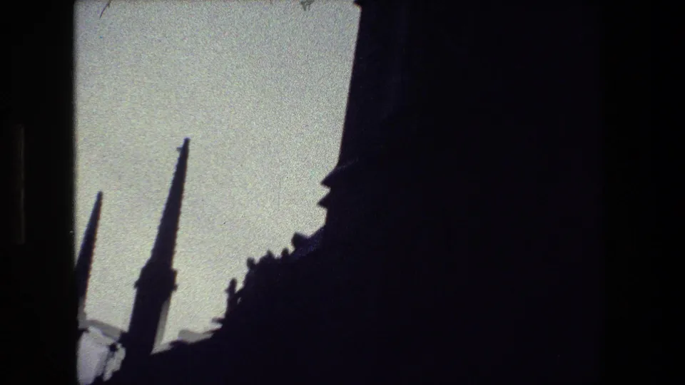 The frame shows a cropped 8mm view of pointed Gothic-style spires and a shadowed building edge, consistent with the supplied 1981 Paris home-movie metadata.