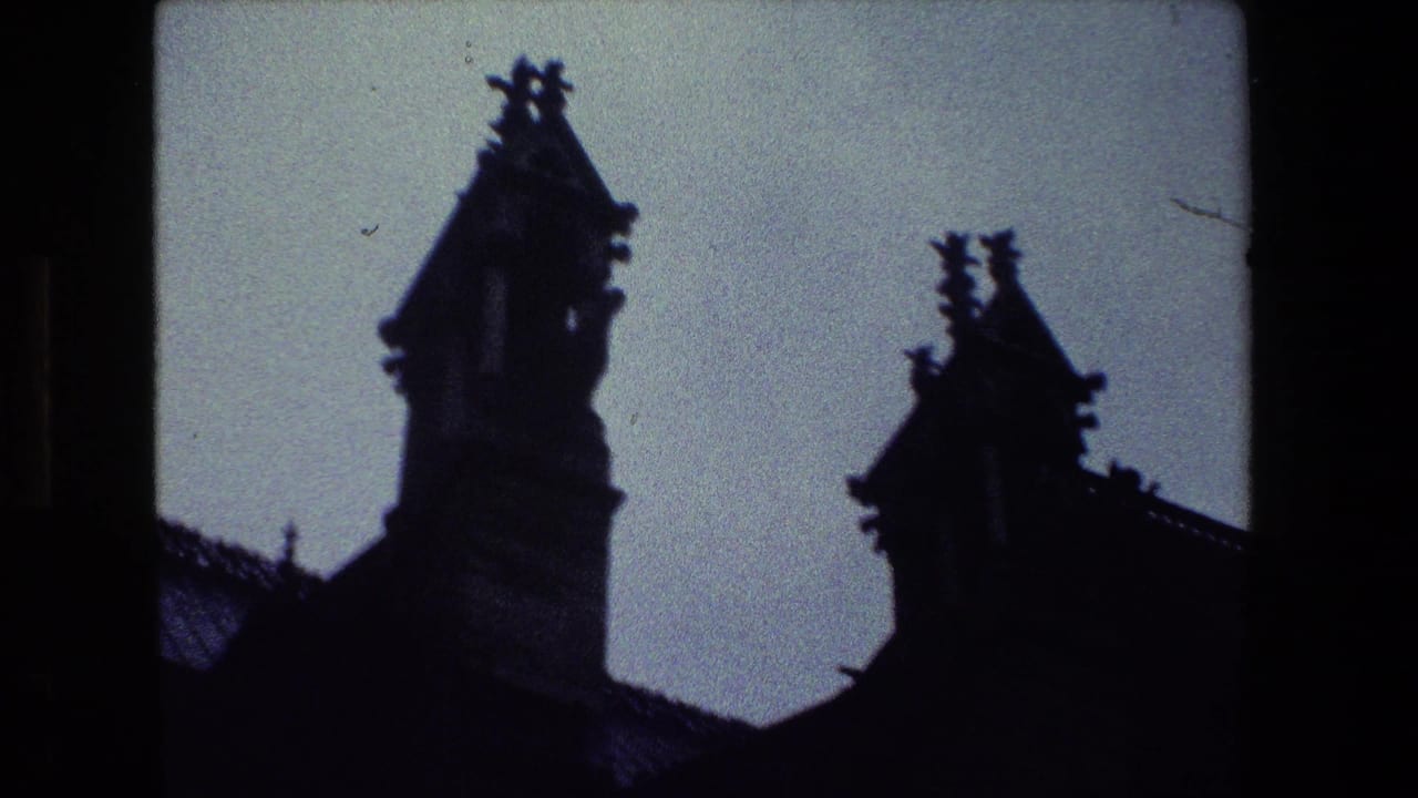 Two dark architectural towers and roof details against the sky.