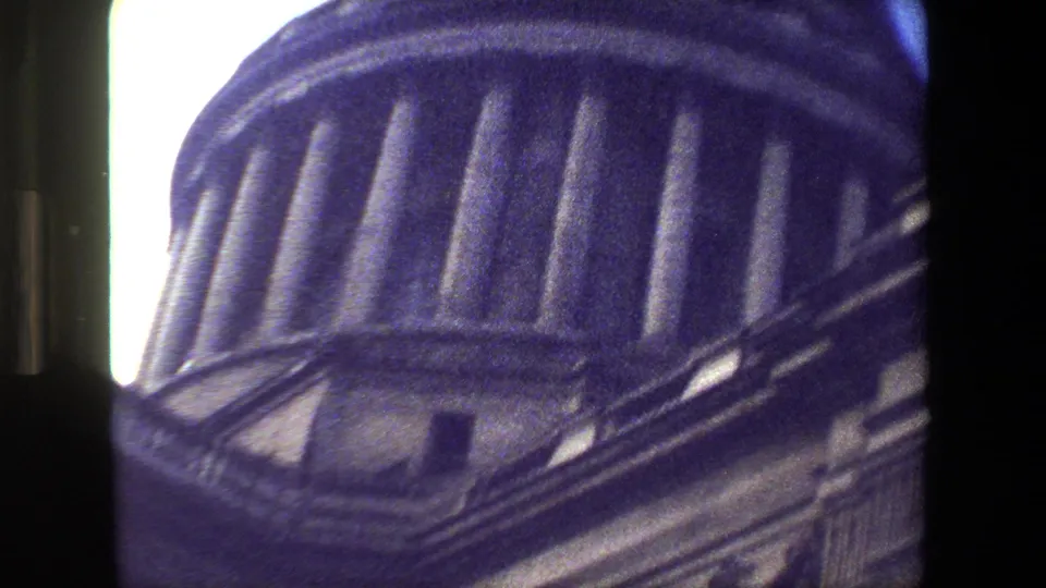 A close handheld view isolates the building's domed roof and upper stonework, with strong grain and purple-blue shadowing from the 8mm scan.