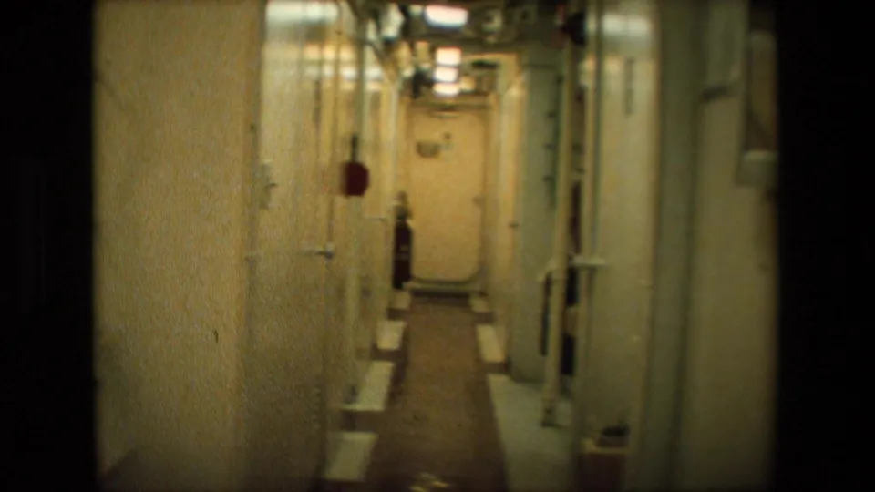 A second below-deck corridor frame shows a utilitarian naval vessel passageway with metal doors, pipes, ceiling lights, and a narrow walking path.