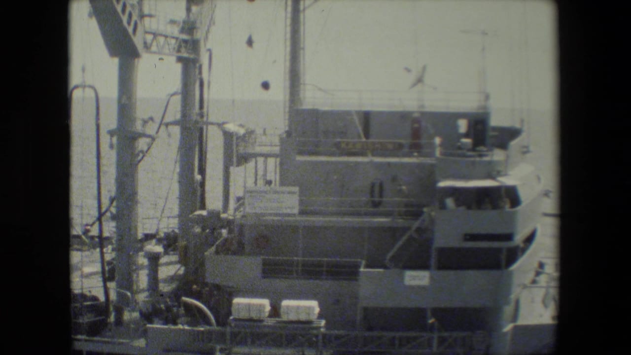 Ship superstructure, mast equipment, and bridge area near the water.