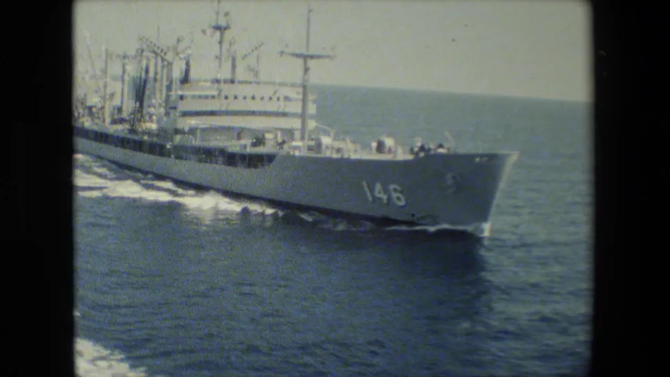 A side view shows the large white vessel marked 146 moving steadily through the sea, with the bow, deck railings, superstructure, and bright ocean wake visible within the rounded 8mm frame.