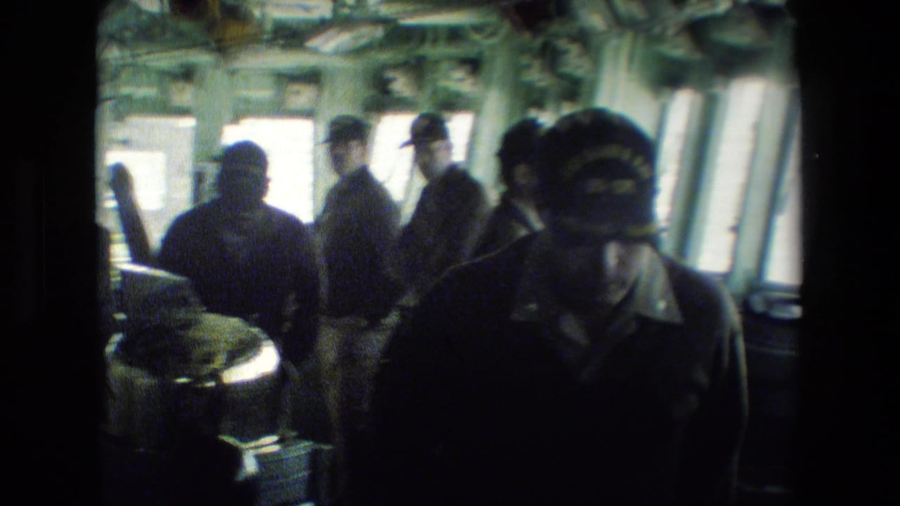 Several uniformed men appear inside the vessel bridge, partly silhouetted against bright windows, with shipboard fixtures and equipment surrounding them.