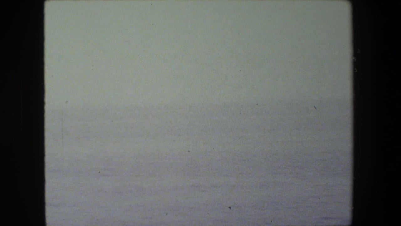 Pale hazy sea view with minimal visible detail.